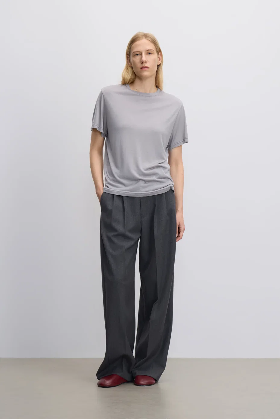 Pale-grey T-shirt with charcoal wide-leg trousers.