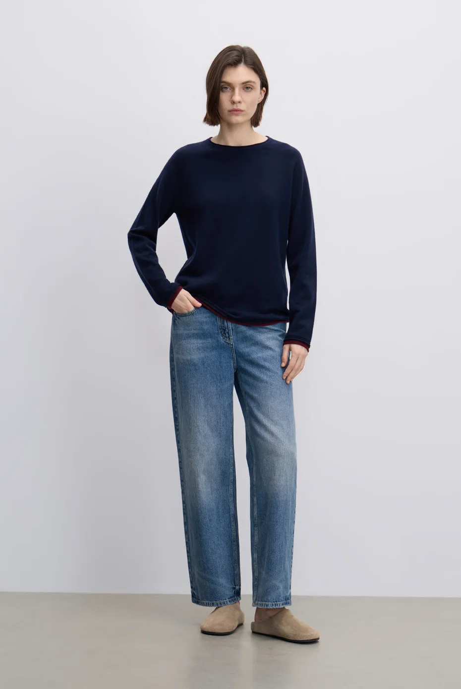 Navy turtleneck knit with blue wide-leg jeans.