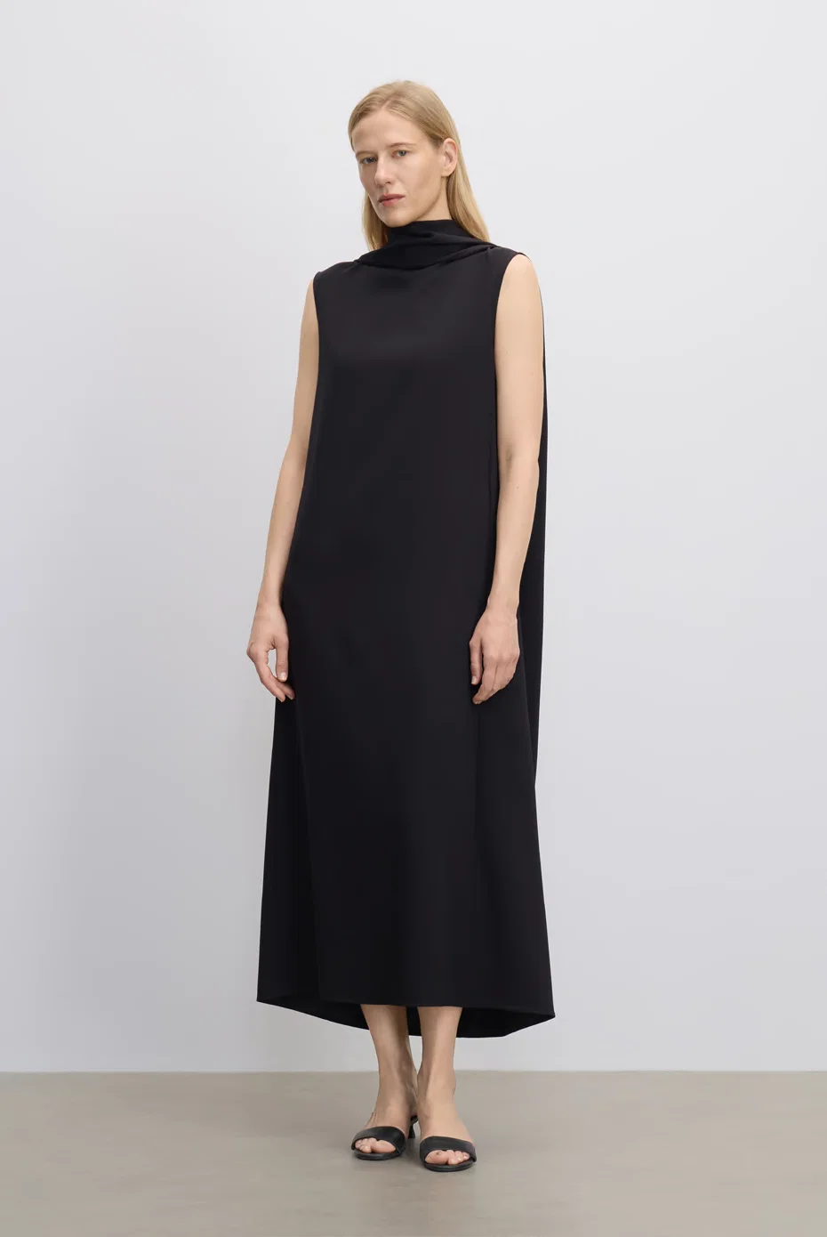 Sleeveless black column midi dress with a clean neckline.