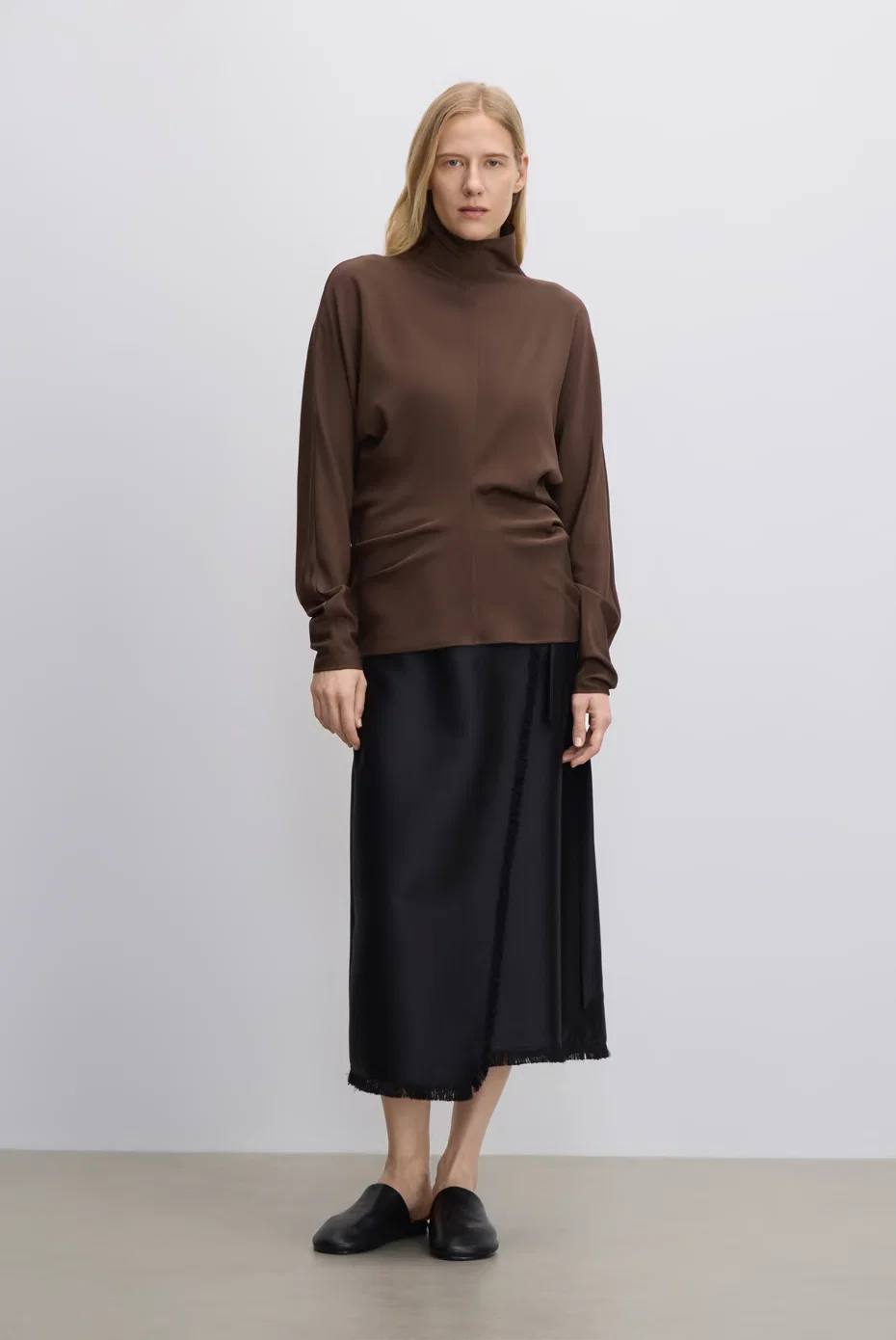 Brown turtleneck knit with a black midi skirt.