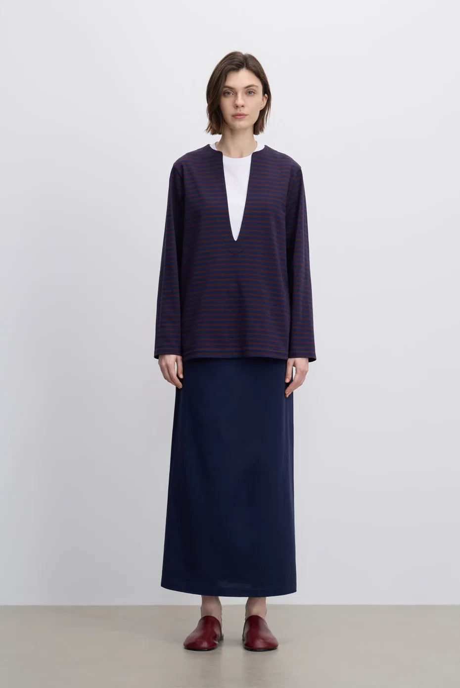 Navy tailored cardigan with a matching long skirt.