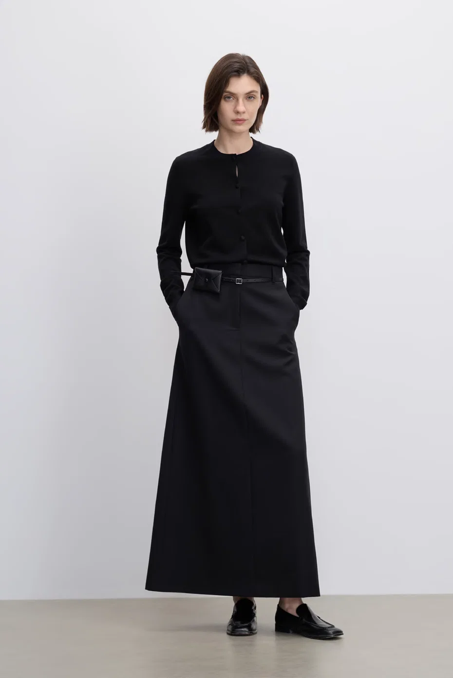 Fitted black knit with a long black A-line skirt.