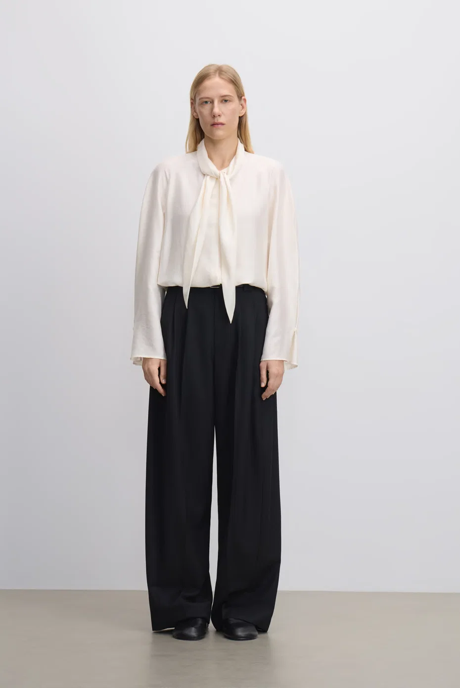 Ivory blouse with tailored black trousers.