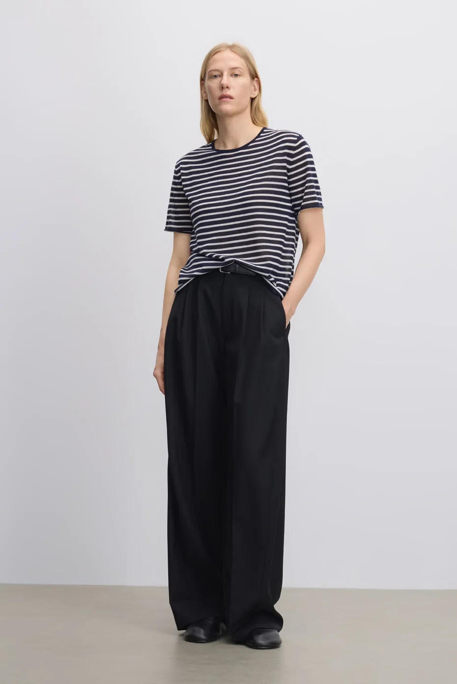 Navy striped short-sleeve knit with black wide-leg trousers.