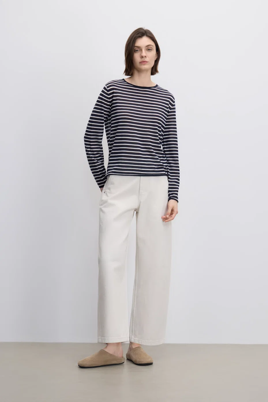 Navy striped sweater with white straight-leg trousers.