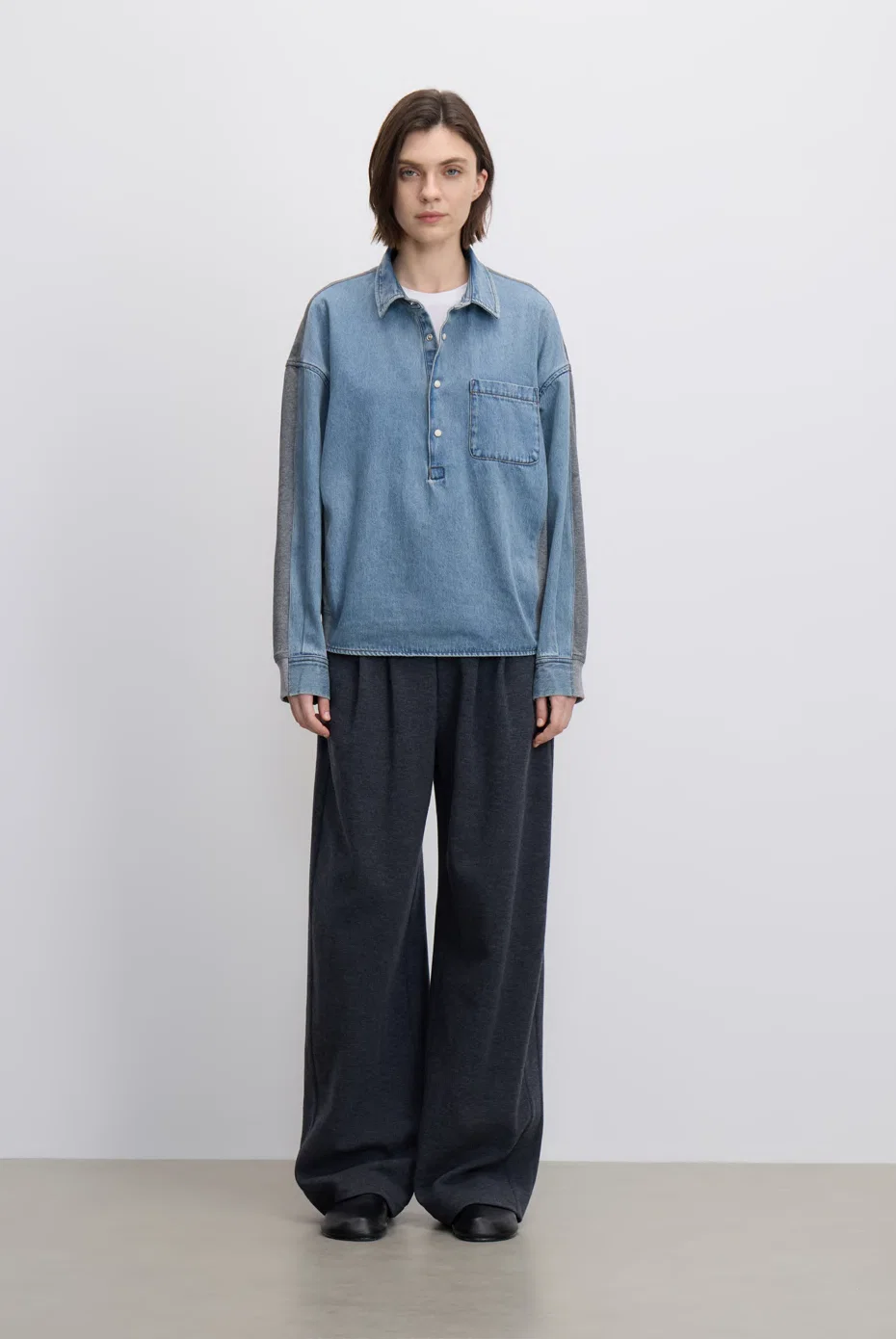 Powder-blue shirt-jacket with charcoal wide-leg trousers.
