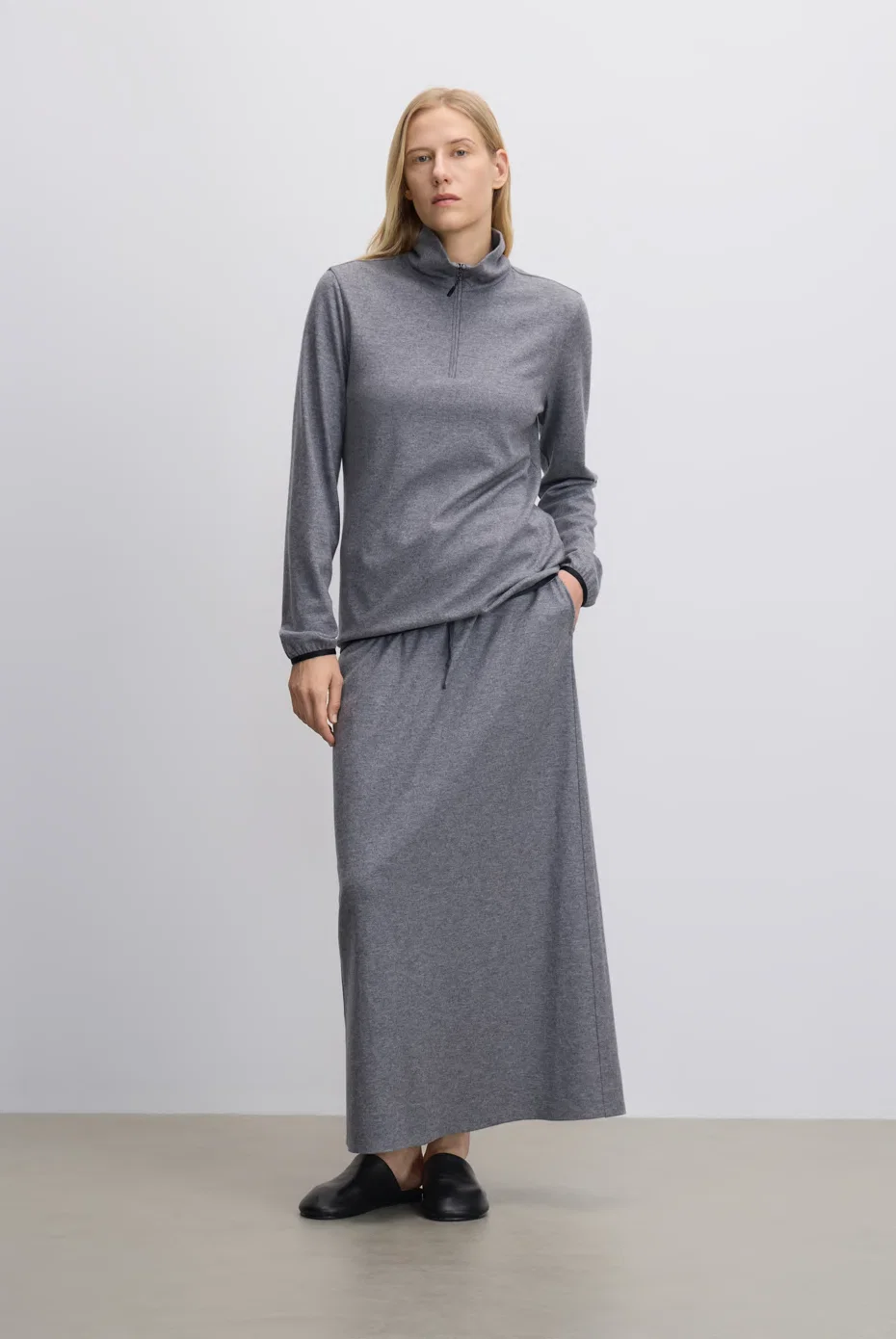 Grey turtleneck top with a matching midi skirt.