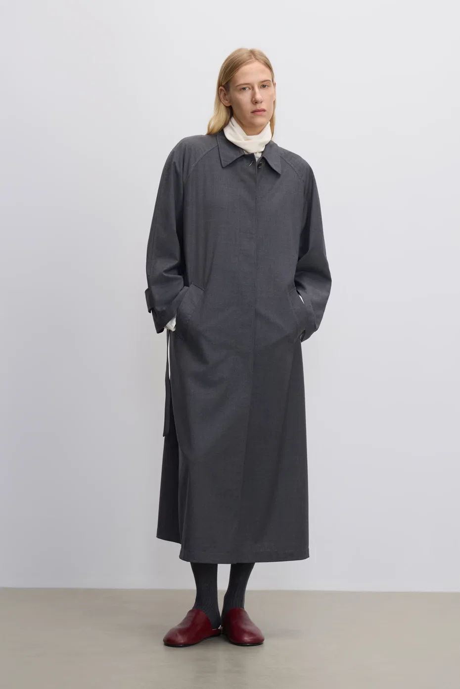Charcoal long shirt dress layered over a white collar, styled with red socks.