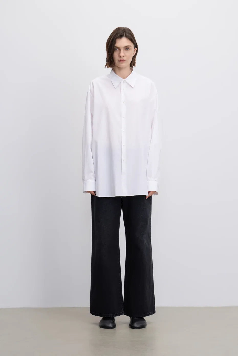 Oversized white shirt with black trousers.