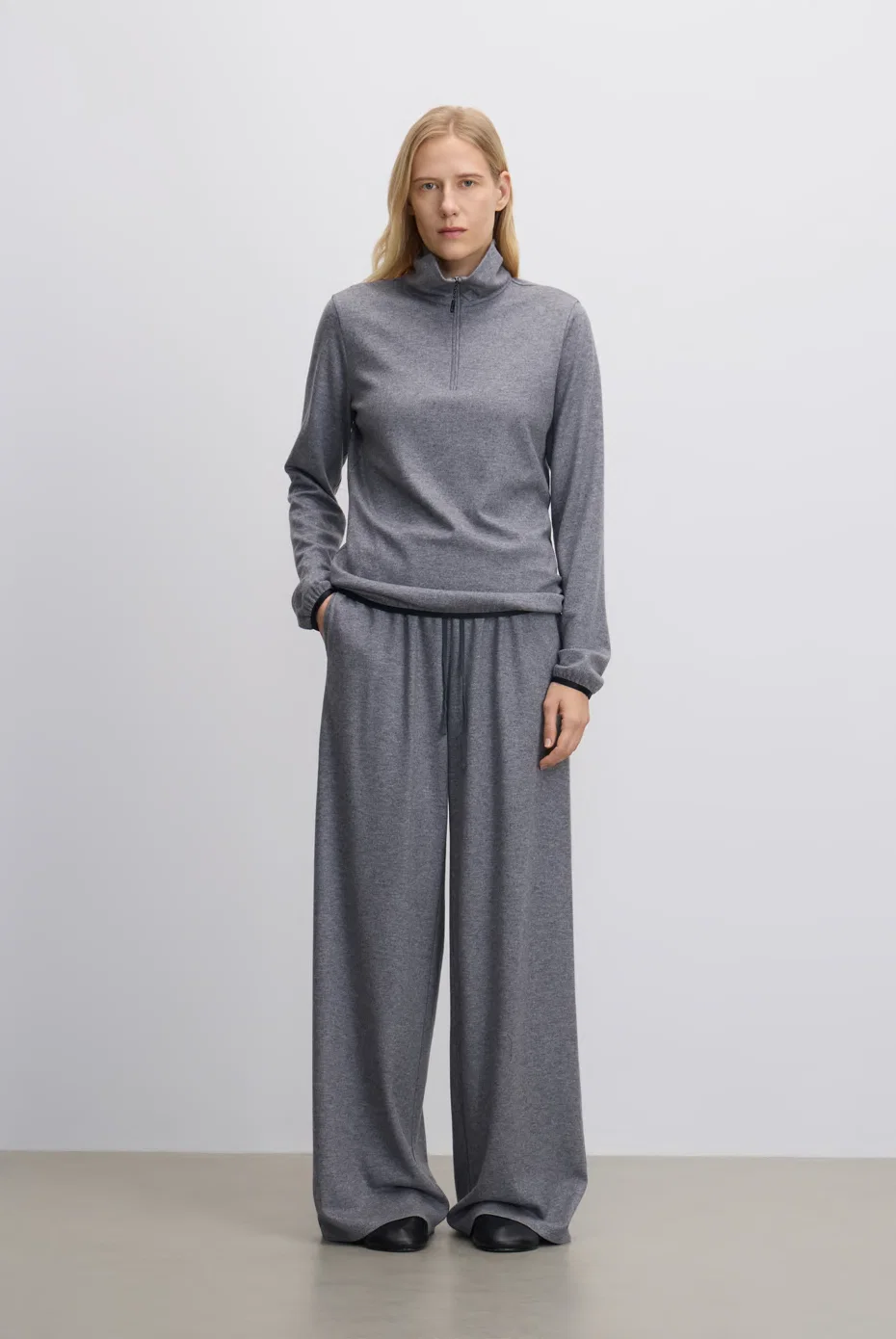 Grey turtleneck top with matching wide-leg trousers.